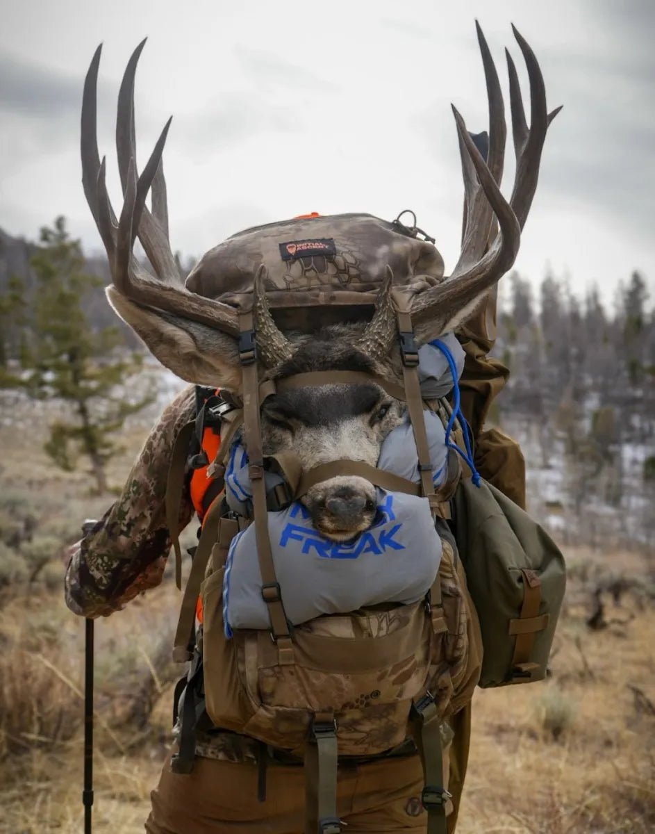 Hunter with Muley Freak game bags attached to backpack, showcasing convenience.