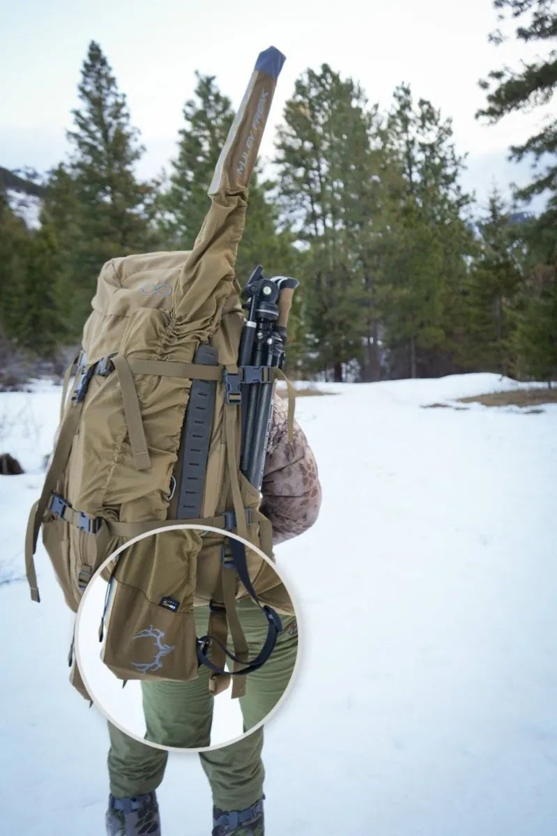 Hunter demonstrating Muley Freak's rifle cover with easy pack connection.
